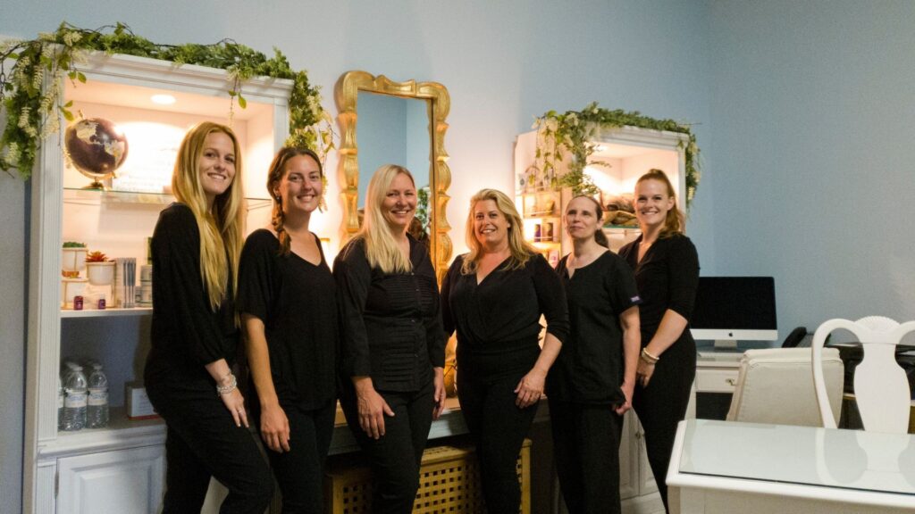 a group of massage therapists pose for a group photo