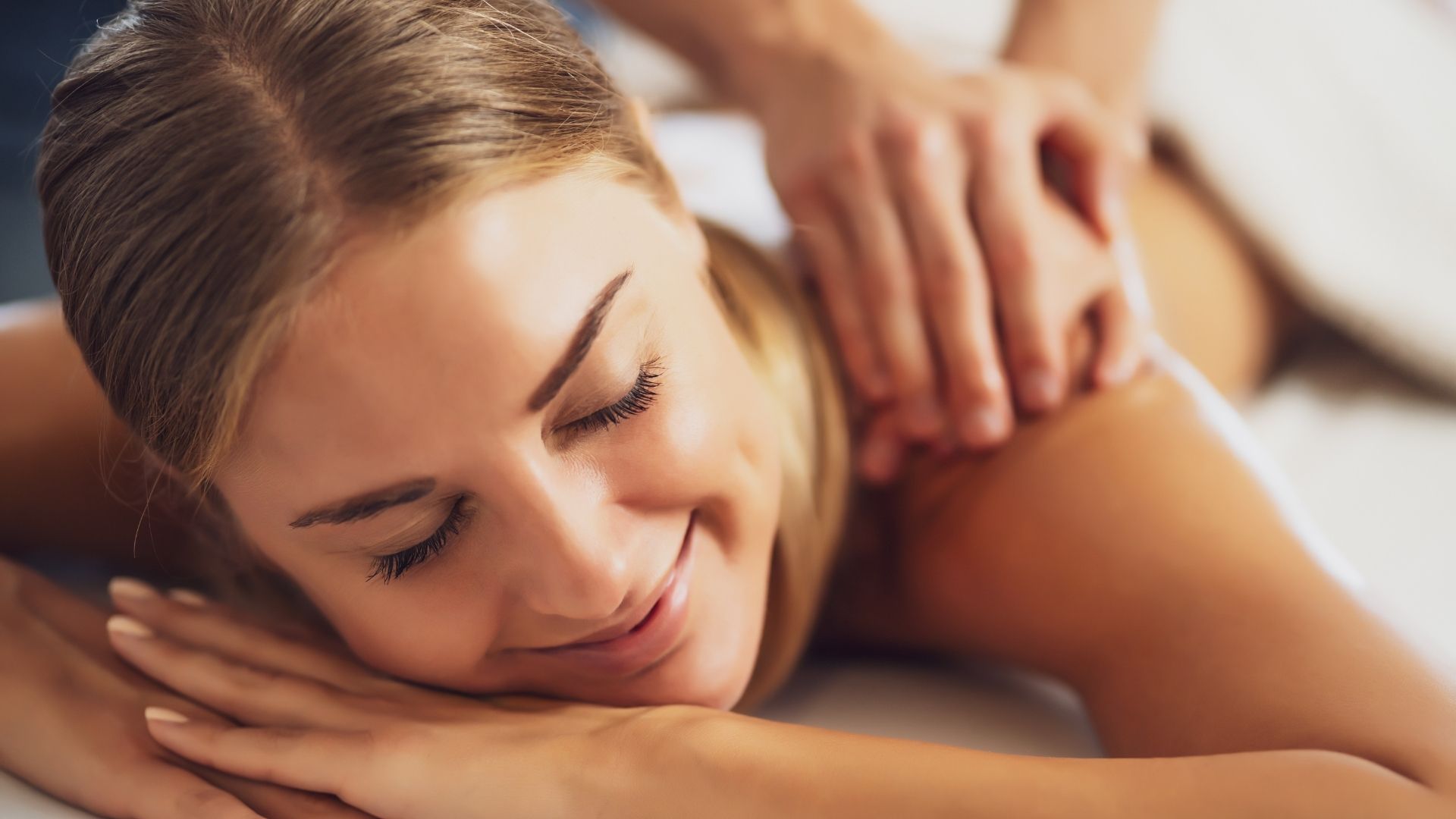 a woman receives a deep tissue massage therapy service