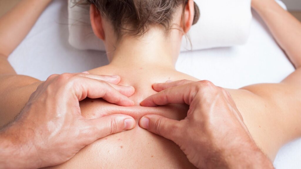 a woman receives myofascial bodywork as part of a massage therapy service